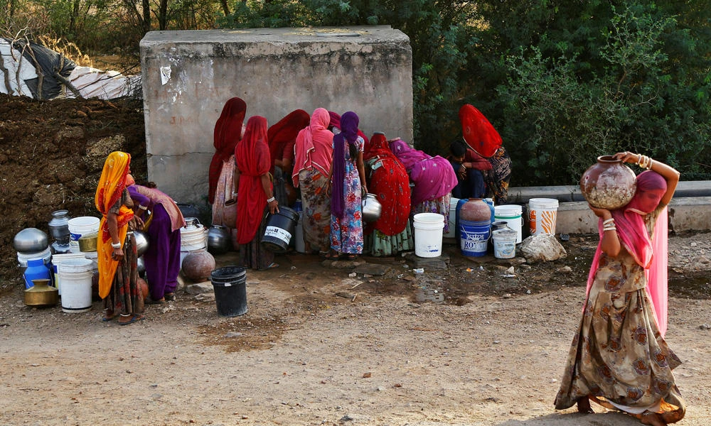 Women fill pitchers and buckets with drinking water from a roadside water tap on a hot summer day at Makreda village on the outskirts of Ajmer, India, on April 28, 2017. India's hardworking women have gotten a boost at least in the state of Madhya Pradesh, with a state minister giving wooden bats to newly-wed brides for use to beat up alcoholic or abusive husbands. (REUTERS/Himanshu Sharma)