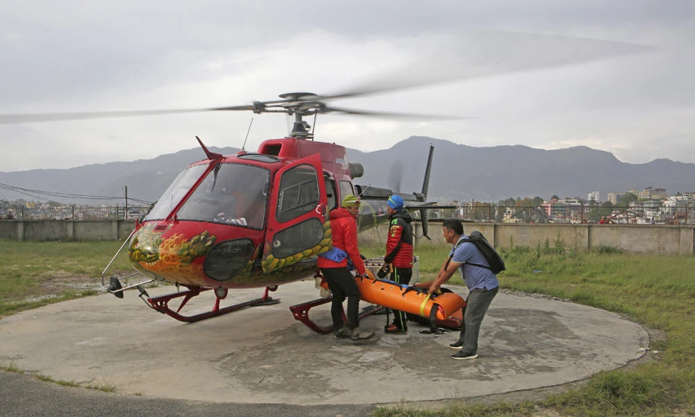 The body of famed Swiss climber Ueli Steck is unloaded from a helicopter at Teaching Hospital in Katmandu, Nepal, on Sunday. (AP Photo/Niranjan Shrestha)