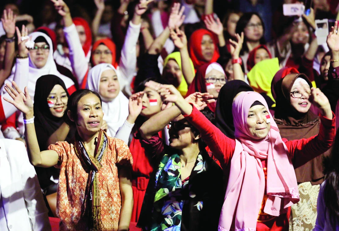 Indonesian expats dance as they wait to meet Indonesian President Joko “Jokowi” Widodo during his two-days visit to Hong Kong on Sunday. (AP)