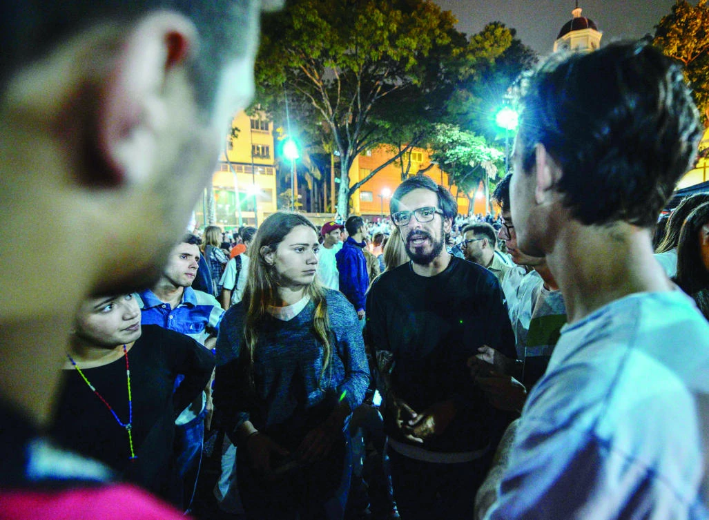 Venezuelan opposition leader Miguel Pizarro, center, talks during a march paying tribute to student Juan Pablo Pernalete — killed on April 26 by the impact of a gas grenade during a protest against President Nicolas Maduro — in Caracas on Saturday. (AFP)