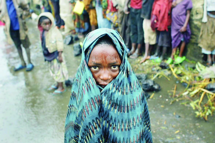 A Congolese child waits in the rain for aid to be distributed in Kibati, eastern DR Congo, in this file photo. (AP)