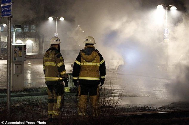 Monday, Feb. 20, 2017, firefighters survey the scene in the suburb of Rinkeby outside Stockholm. (AP)