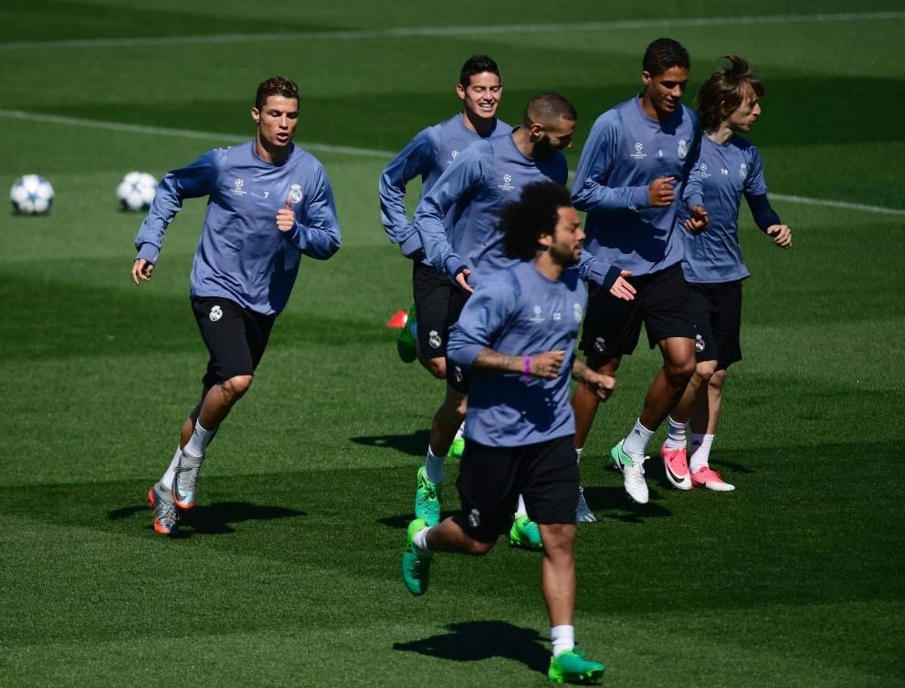 Real Madrid's Portuguese forward Cristiano Ronaldo, left, runs with teammates during a training session at Valdebebas Sport City in Madrid on Monday on the eve of their Champions' League semifinal first leg football match against Atletico de Madrid. (AFP)