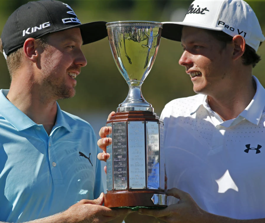 Jonas Blixt, of Sweden, left, and teammate Cameron Smith, of Australia, hold up their tournament trophy after they won a sudden-death playoff for the PGA Zurich Classic golf tournament's new two-man team format at TPC Louisiana in Avondale, La., Monday. The pair defeated Kevin Kisner and Scott Brown. (AP)