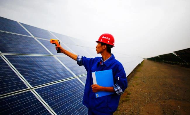 A worker inspects solar panels at a solar farm in Dunhuang, 950km northwest of Lanzhou, Gansu Province, in this file photo taken on September 16, 2013. (Reuters)