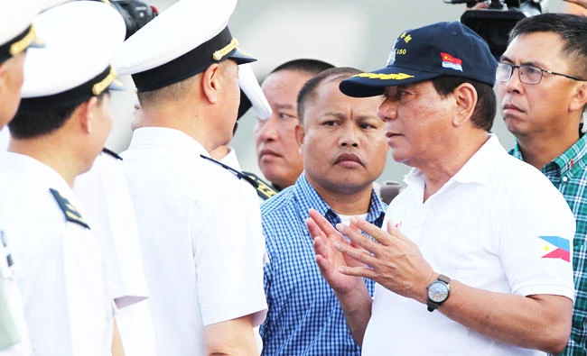 Philippine President Rodrigo Duterte talks to Chinese Navy officers as he tours a Chinese Naval ship during a visit to Davao city, southern Philippines on Monday. (REUTERS)