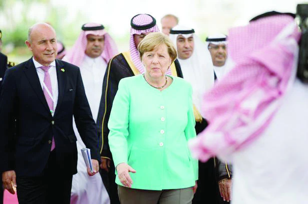 German Chancellor Angela Merkel walks with German Ambassador Dieter W. Haller on arrival in Jeddah on Sunday. (AN photo)