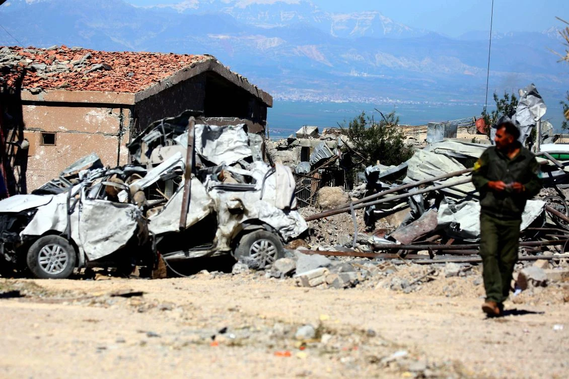 A fighter from the Kurdish People’s Protection Units (YPG) visits the site of Turkish airstrikes near northeastern Syrian Kurdish town of Derik on April 25. (AFP)
