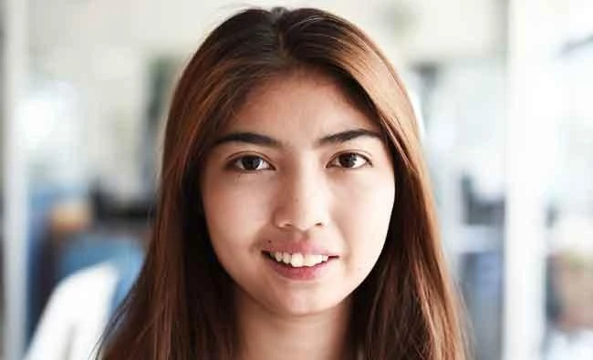 This photo taken on April 21, 2017 shows Thai schoolgirl Naruedee Jotsanthia smiling for the camera at the Paveena Foundation in Bangkok. (AFP)