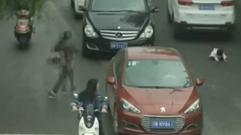 Video of a toddler who survived being run over by two sport utility vehicles in southwest China went viral this week. (AP)