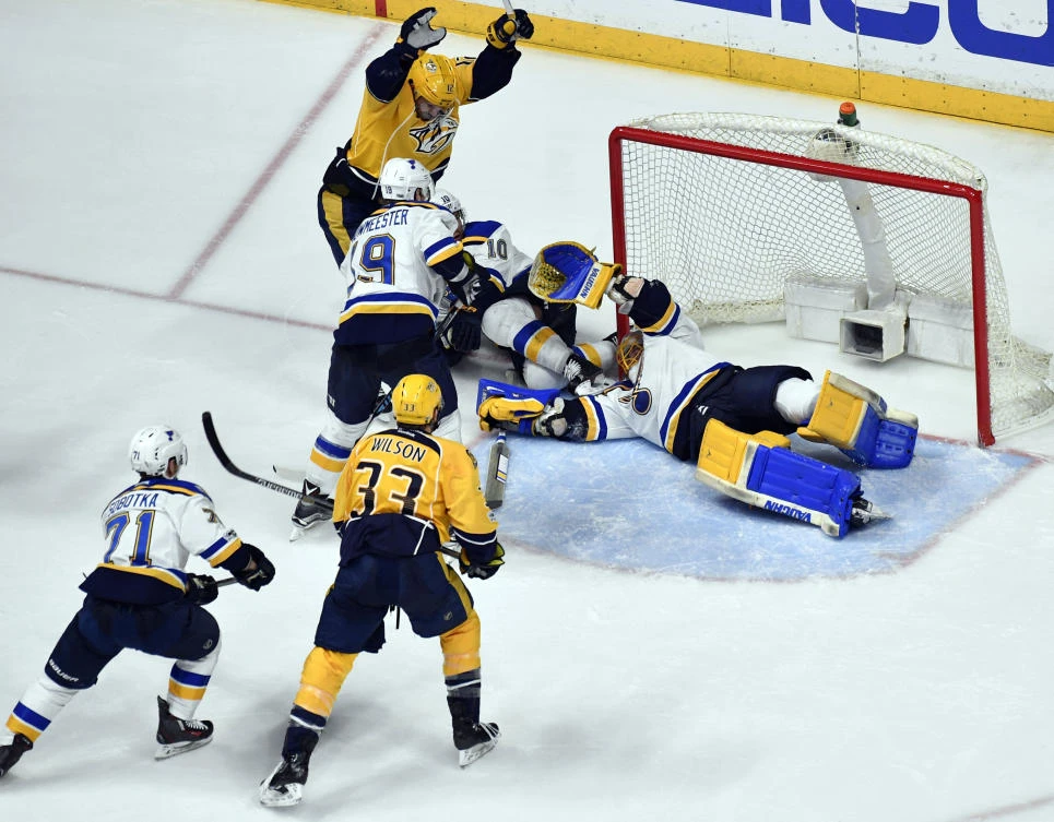St. Louis Blues goalie Jake Allen (34) reacts as Nashville Predators center Mike Fisher (12) celebrates following a goal by Nashville Predators defenseman Ryan Ellis (not pictured) in game four of the second round of the Stanley Cup Playoffs at Bridgestone Arena on Tuesday night. (USA TODAY Sports)