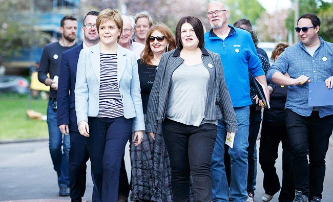 Scottish National Party (SNP) leader Nicola Sturgeon (C) joins SNP Glasgow Group leader Susan Aitken (R) campaigning in Glasgow on May 3, 2017 on the eve of local elections. (AFP)