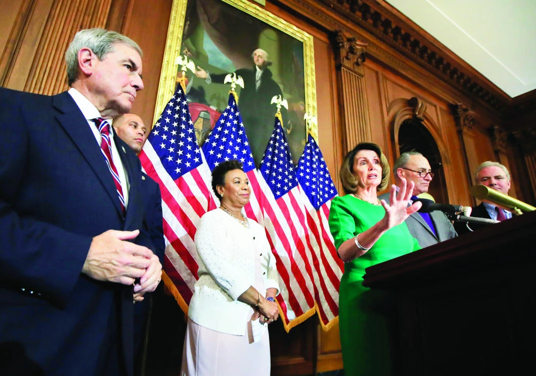 House Minority Leader Nancy Pelosi, center, speaks to reporters about President Donald Trump’s first 100 days,
at the Capitol Hill in Washington, on Friday. (AP)