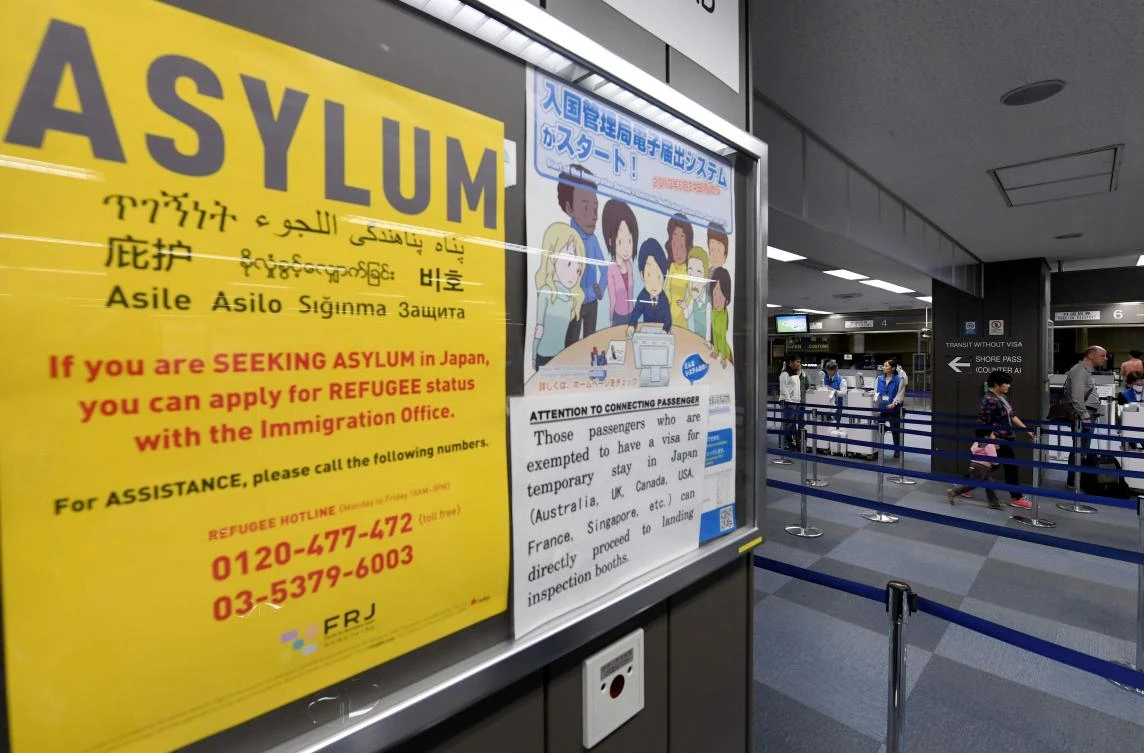 This picture taken on April 28, 2017 shows a poster near the passport control counter of the immigration office at the Narita International airport in Narita. (AFP)