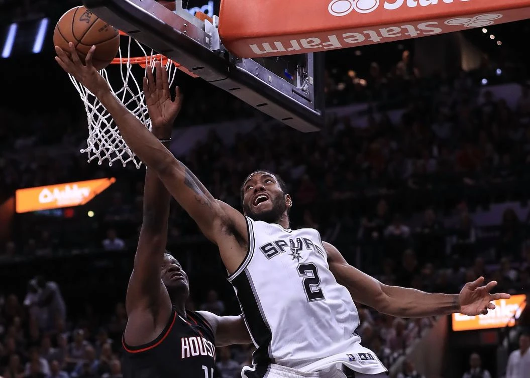 Kawhi Leonard, of the San Antonio Spurs, drives against Clint Capela, of the Houston Rockets, during Game 2 of the NBA Western Conference Semifinals at AT&T Center on Wednesday in San Antonio, Texas. (AFP)