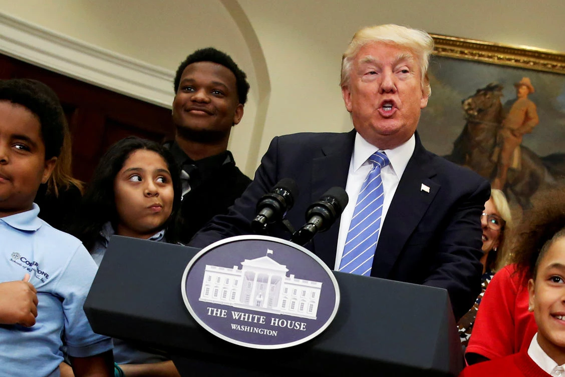 US President Donald Trump is surrounded by local schoolchildren as he delivers remarks at a school choice event at the White House in Washington, on Wednesday. (Reuters)