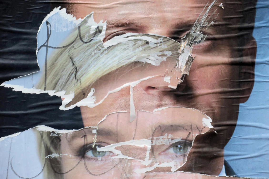 Torn and overlapping official posters of candidates for the 2017 French presidential election Marine Le Pen of French National Front (FN) political party, and Emmanuel Macron, head of the political movement En Marche !, or Onwards !, are seen in Cambrai, France, on May 4, 2017. (REUTERS/Pascal Rossignol)