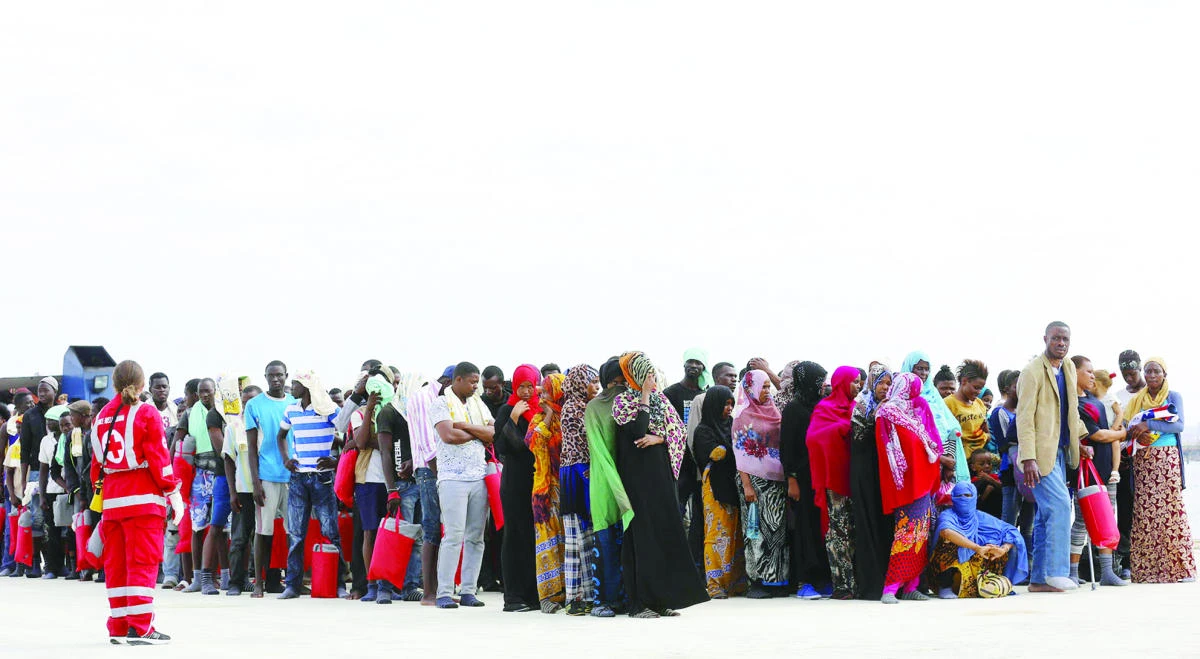 Migrants wait on the dock in Augusta, Sicily, after being rescued. (Reuters)