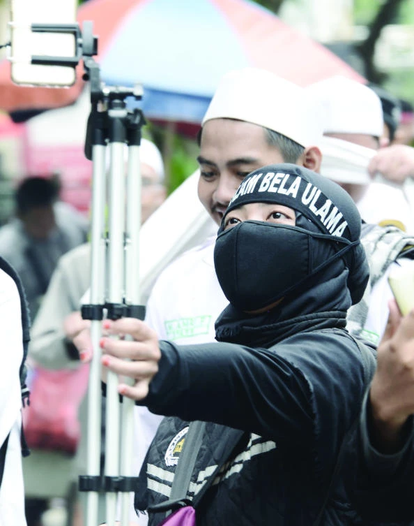 A protester takes a selfie during a demonstration in Jakarta on Friday. (AFP)