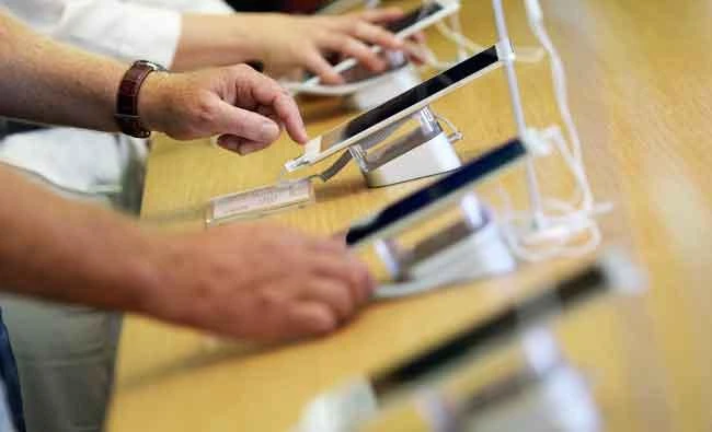 Visitors touch Huawei tablets at the IFA Electronics show in Berlin, Germany, in this September 2, 2016 file photo. (REUTERS)