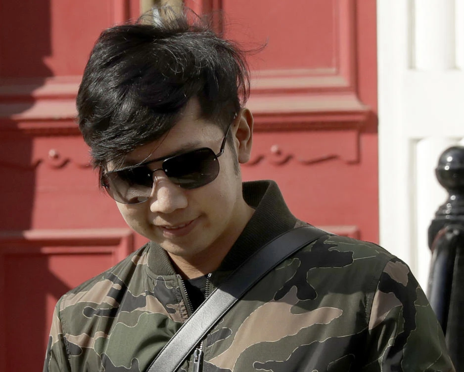 Vorayuth "Boss" Yoovidhya, whose grandfather co-founded energy drink company Red Bull, walks to get in a car as he leaves a house in London onApril 5, 2017. (AP Photo/Matt Dunham, File)