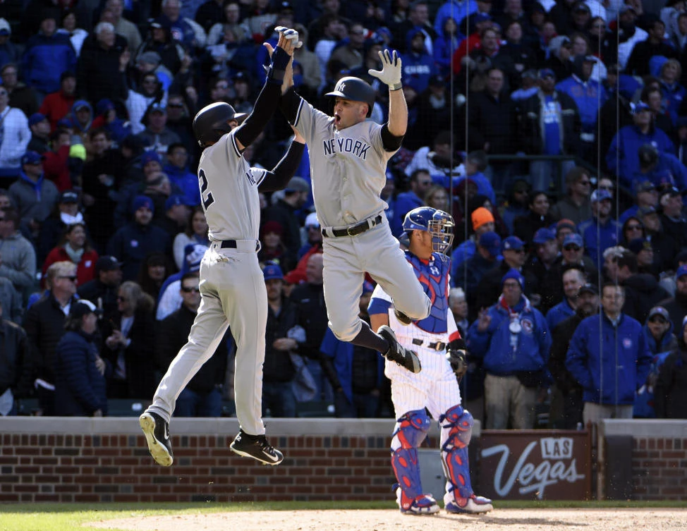 New York Yankees left fielder Brett Gardner, right, celebrates his three-run home run with center fielder Jacoby Ellsbury (22) against the Chicago Cubs during the ninth inning at Wrigley Field on Friday night. (USA TODAY Sports)