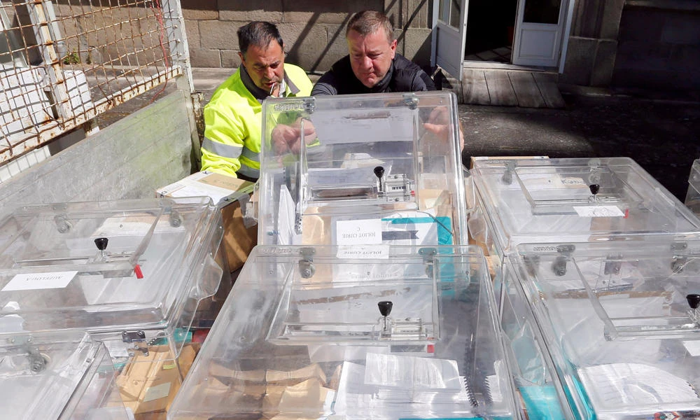 Municipal employees prepare ballot boxes on the eve of the first round of the French presidential election at a polling station in Tulle, France. (REUTERS/Regis Duvignau)