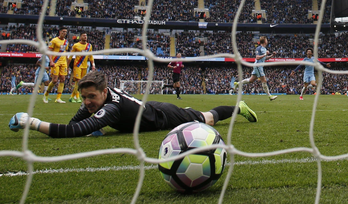 Manchester City's Kevin De Bruyne celebrates scoring their third goal as Crystal Palace's Wayne Hennessey looks dejected during the Manchester City vs. Crystal Palace Premier League match at Etihad Stadium on Saturday. (Reuters)