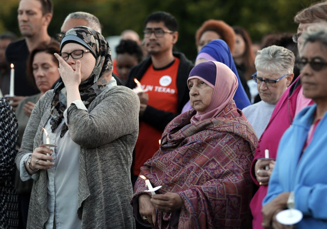 A couple of hundred supporters stand holding lit candles as they listen to comments from speakers during a vigil for Jordan Edwards in Balch Springs, Texas. (AP)