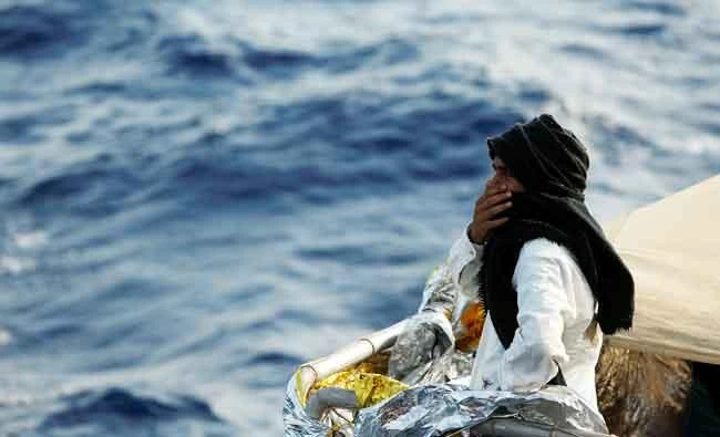A migrant looks out towards the Maltese island of Gozo as the Malta-based NGO Migrant Offshore Aid Station (MOAS) ship Phoenix makes its way towards Italy after rescue operations off the coast of Libya, on Friday. (REUTERS)