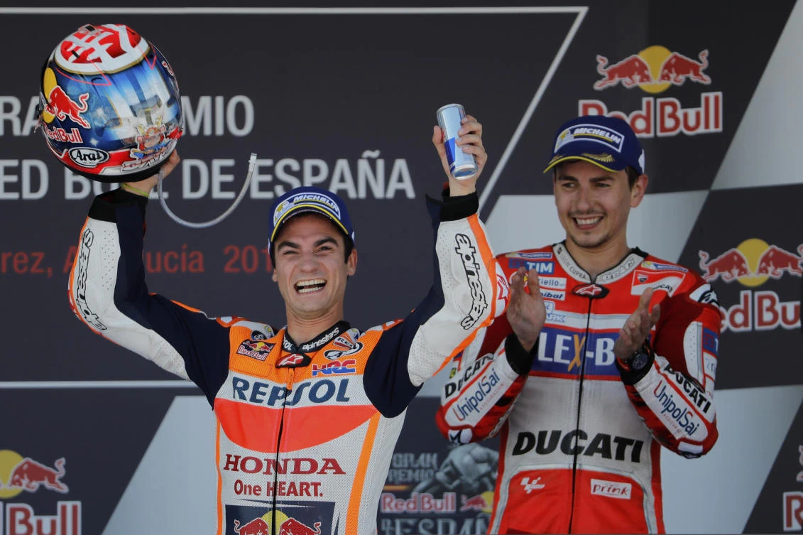 Third placed MotoGP rider Jorge Lorenzo of Spain, right, applauds as MotoGP race winner Dani Pedrosa of Spain celebrates at the Spanish Motorcycle Grand Prix at the Jerez racetrack in Jerez de la Frontera, Spain, Sunday. (AP)