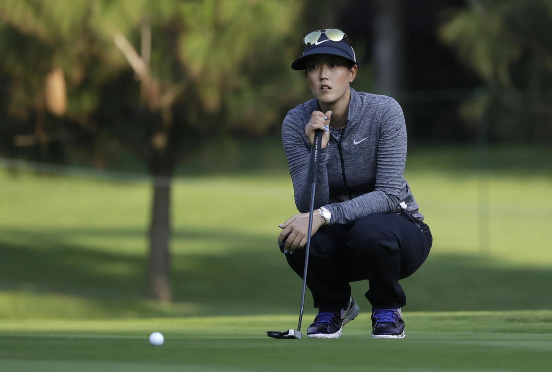 Michelle Wie, of the US, prepares to putt on the 2nd hole during round three of the Lorena Ochoa Invitational at Mexico Golf Club in Mexico City Saturday. (AP)