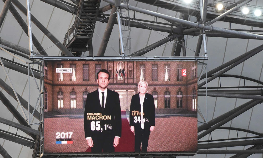 The results of the second and final round of the French presidential election, are displayed on a giant screen installed at the Velodrome Stadium in Marseille, on Sunday. (AFP / BORIS HORVAT)