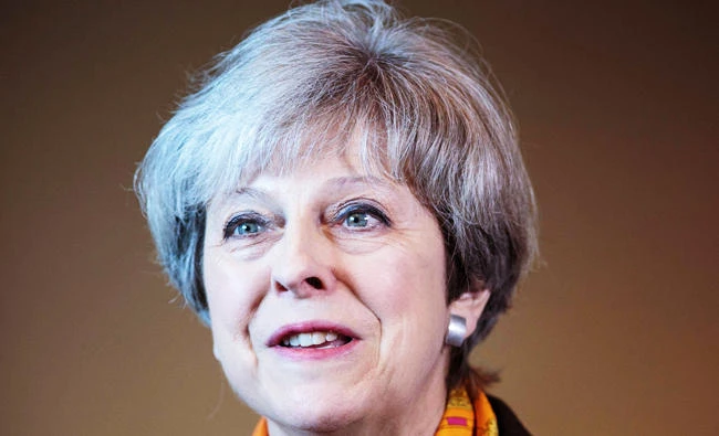 Britain's Prime Minister Theresa May addresses the media at the end of her tour of the Octink sign manufacturer factory in Brentford, west London, in this photo taken on May 5, 2017. (AFP)