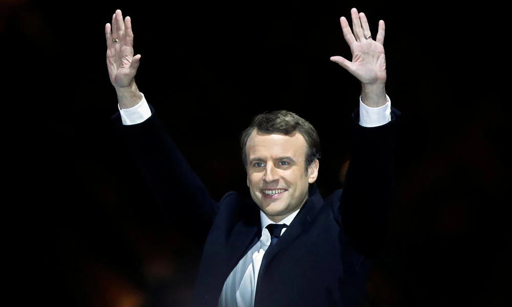 French President-elect Emmanuel Macron celebrates on the stage at his victory rally near the Louvre in Paris on Sunday. (REUTERS/Christian Hartmann)