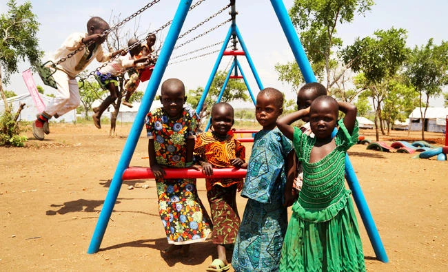 In this photo taken on March 14, 2017, South Sudanese refugee children play outside a temporary school in Bidi Bidi camp, northern Uganda. (AP)