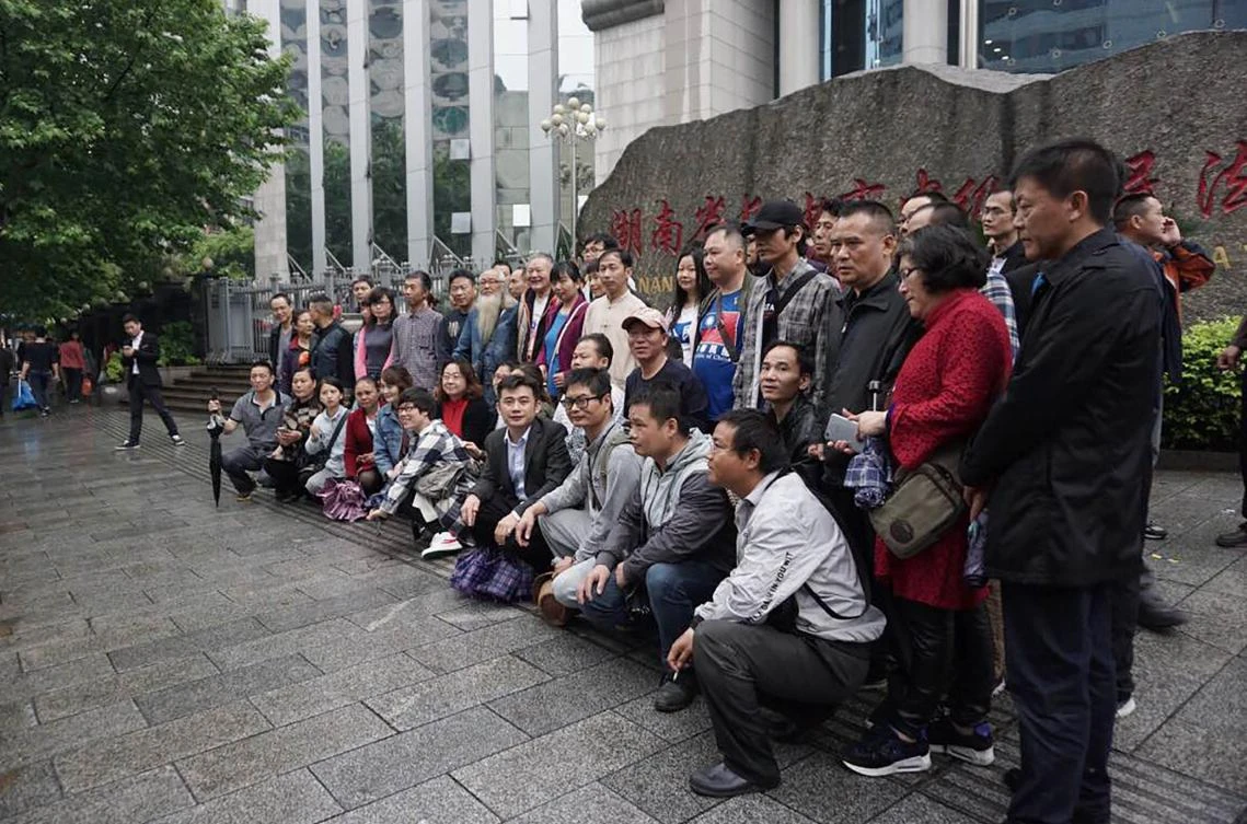 Supporters of lawyer Xie Yang gather outside the Intermediate People's Court in Changsha on April 25, 2017. The court indefinitely postponed the trial of the prominent human rights lawyer on April 25, his supporters said, in a case that has sparked international concern after allegations he was tortured. (AFP)