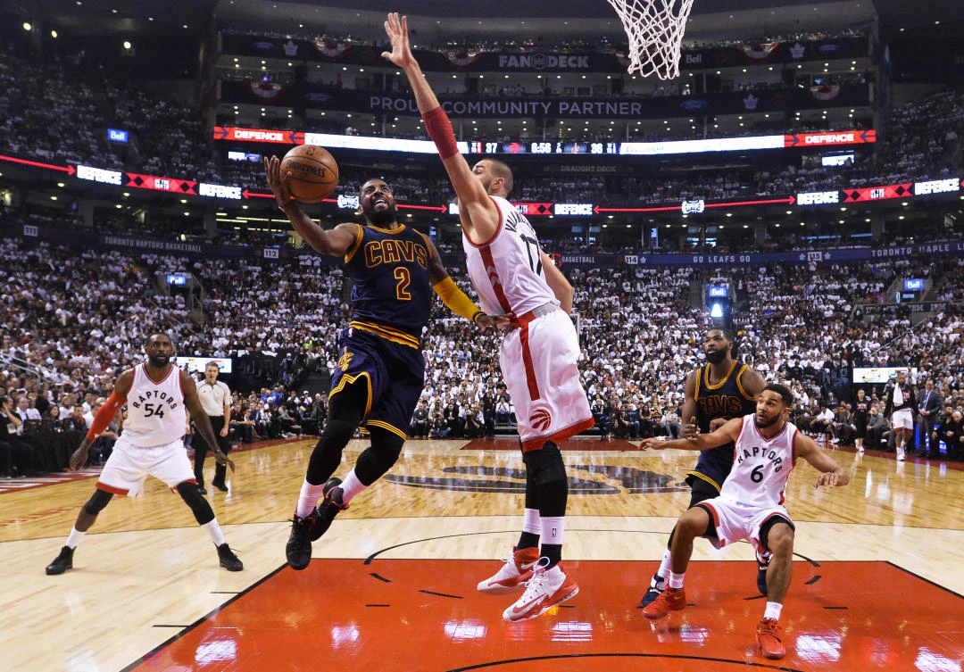 Cleveland Cavaliers guard Kyrie Irving drives to the basket against Toronto Raptors center Jonas Valanciunas during first half Eastern Conference semifinal NBA basketball action in Toronto on Sunday. (AP)