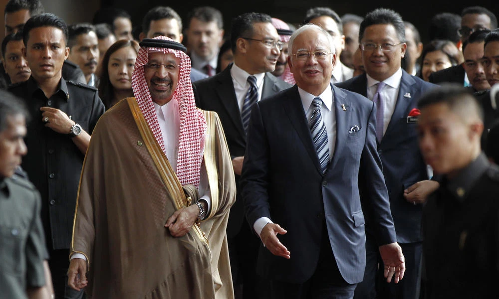 Saudi's Energy Minister Khalid Al-Falih, center left, walks with Malaysian Prime Minister Najib Razak, center right, to attend an Oil and Gas Conference at Kuala Lumpur Convention Center on Monday. (AP Photo/Daniel Chan)