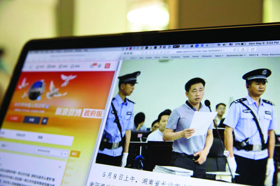A photo of human rights lawyer Xie Yang is displayed on a computer screen in Beijing. (AP)