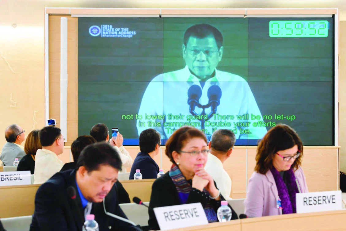 People listen to a speech delivered by Philippines’ President Rodrigo Duterte shown on a screen during the universal periodic review of the Philippines by the Office of the UN High Commissioner for Human Rights in Geneva on Monday. (AFP)