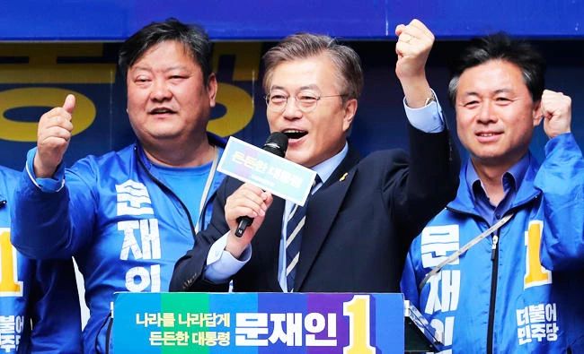South Korea's presidential candidate Moon Jae-in of the Democratic Party, center, speaks during an election campaign in Busan, South Korea, on Monday. (AP)