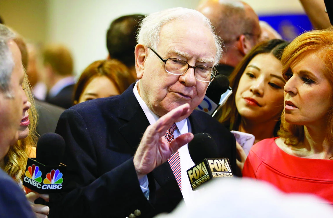 Warren Buffett talks with a reporter before the Berkshire Hathaway annual meeting in Omaha, Nebraska last Saturday. (Reuters)