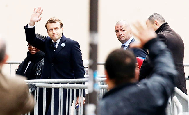 French President elect Emmanuel Macron waves as he arrives at his campaign headquarters in Paris, France, on Monday. (Reuters)