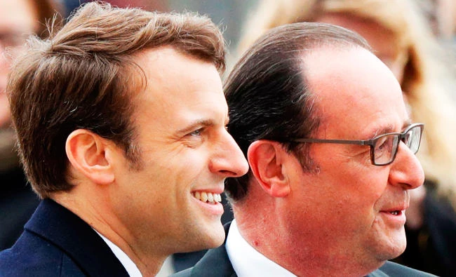 Outgoing French President Francois Hollande (R) stands by President-elect Emmanuel Macron (L) as they attend a ceremony marking the 72nd anniversary of the victory over Nazi Germany during World War II on Monday in Paris. (AFP)