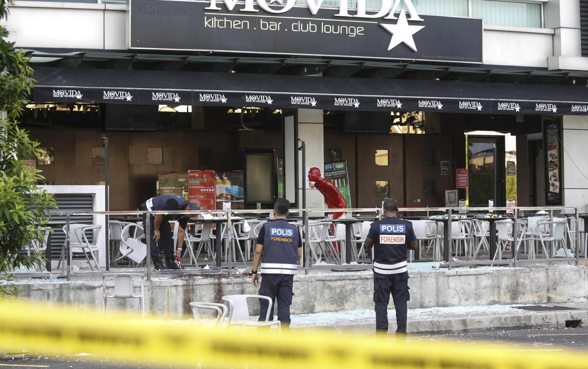 File photo: Malaysian forensic personnel inspect the blast site of a grenade attack at a bar and restaurant in Puchong, outside Kuala Lumpur, Malaysia.(AP)