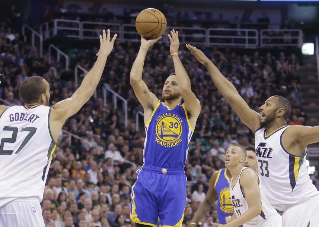 Golden State Warriors guard Stephen Curry (30) shoots as Utah Jazz's Rudy Gobert (27) and Boris Diaw defend in the first half during Game 4 of the NBA basketball second-round playoff series Monday in Salt Lake City. (AP)