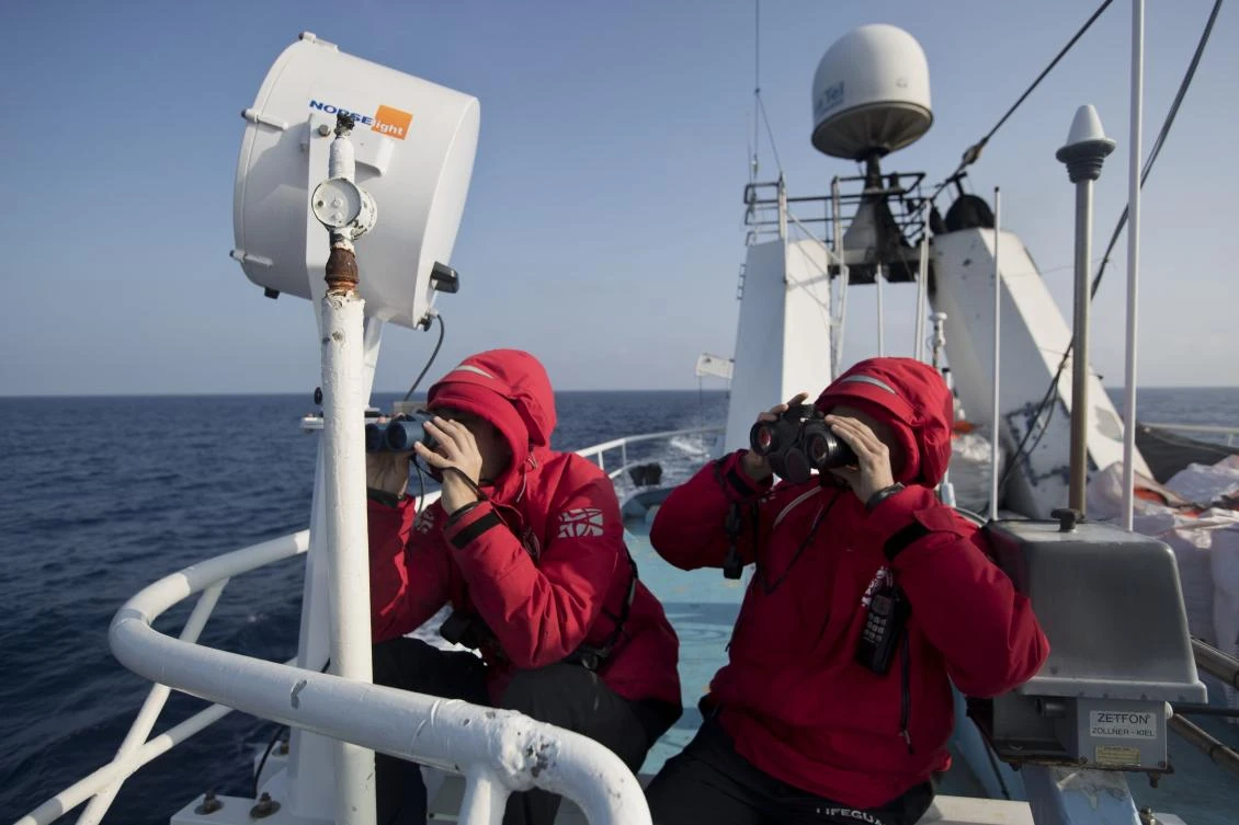 This is an April 13, 2017, file photo of Proactiva Open Arms crew as they conduct a search and rescue operation in the Mediterranean sea, 14 nautical miles from the Libyan coast. UN agencies say up to 245 migrants and refugees are missing and feared dead following two shipwrecks in recent days in the Mediterranean Sea. (AP Photo/Bernat Armangue/File)