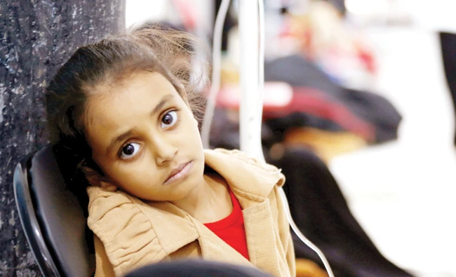 A girl-infected with cholera sits on a chair at a hospital in Sanaa, Yemen on Sunday. (Reuters)