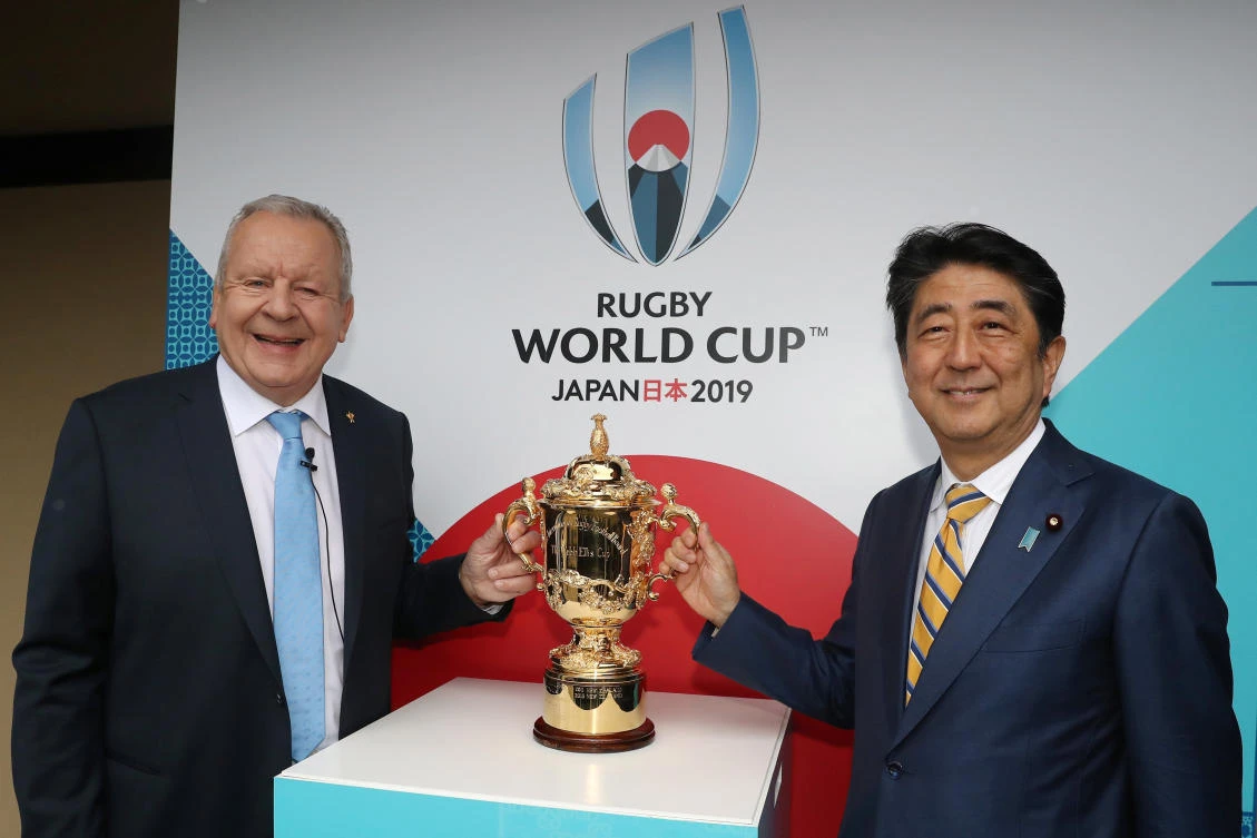 Bill Beaumont, chairman of World Rugby, left, and Shinzo Abe, prime minister of Japan, pose with the William Webb Ellis Cup during the Rugby World Cup 2019 Pool Draw at the Kyoto State Guest House in Kyoto, western Japan Wednesday. (Reuters)